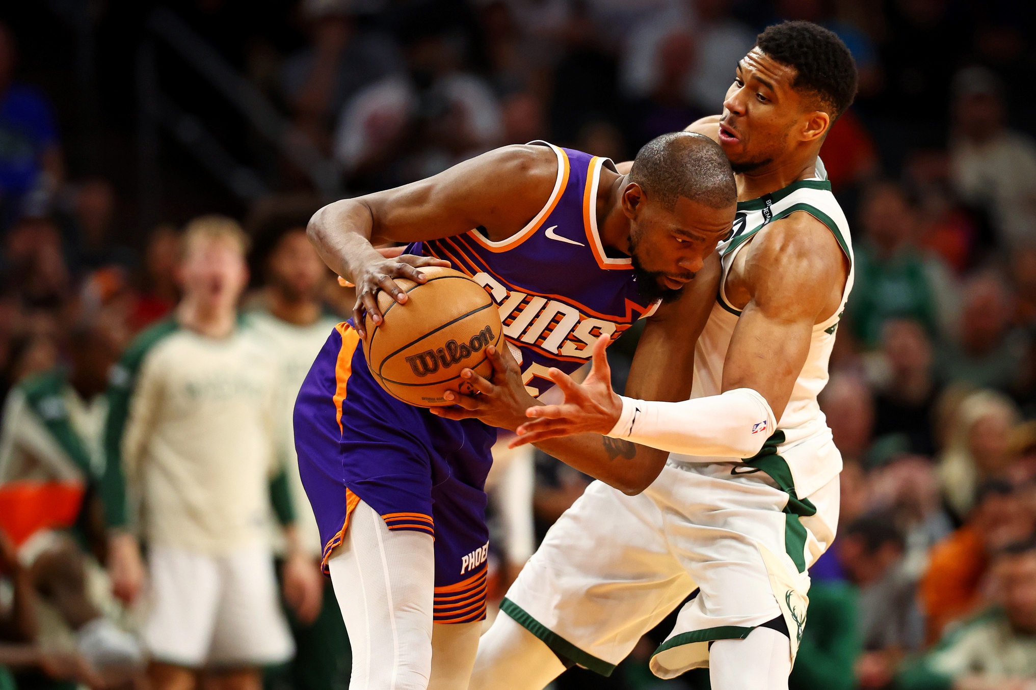 Phoenix Suns forward Kevin Durant (35) handles the ball against Milwaukee Bucks forward Giannis Antetokounmpo (34) during the fourth quarter at Footprint Center.