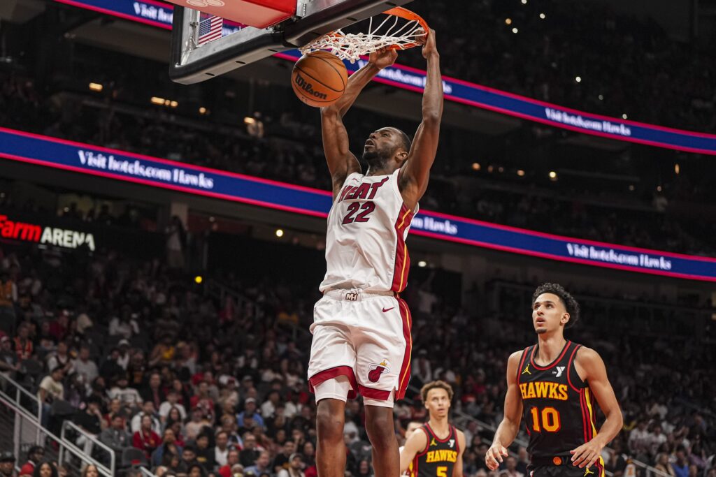 Apr 18, 2025; Atlanta, Georgia, USA; Miami Heat forward Andrew Wiggins (22) dunks behind Atlanta Hawks forward Zaccharie Risacher (10) during the second half at State Farm Arena. Mandatory Credit: Dale Zanine-Imagn Images