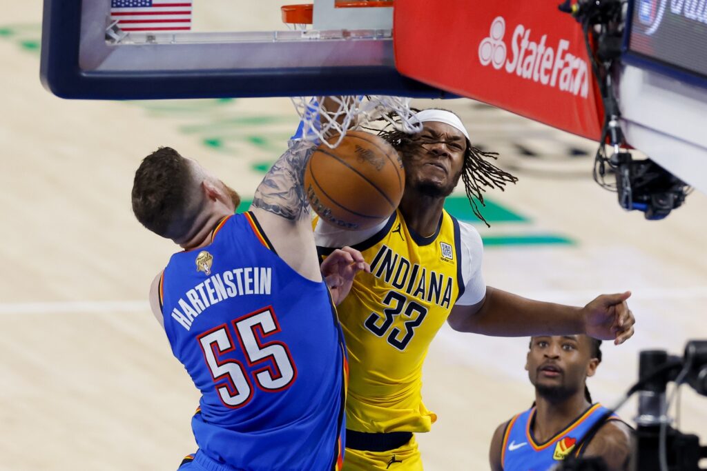 Jun 8, 2025; Oklahoma City, Oklahoma, USA; Oklahoma City Thunder center Isaiah Hartenstein (55) and Indiana Pacers center Myles Turner (33) battle for the ball during the fourth quarter of game two of the 2025 NBA Finals at Paycom Center. Mandatory Credit: Alonzo Adams-Imagn Images