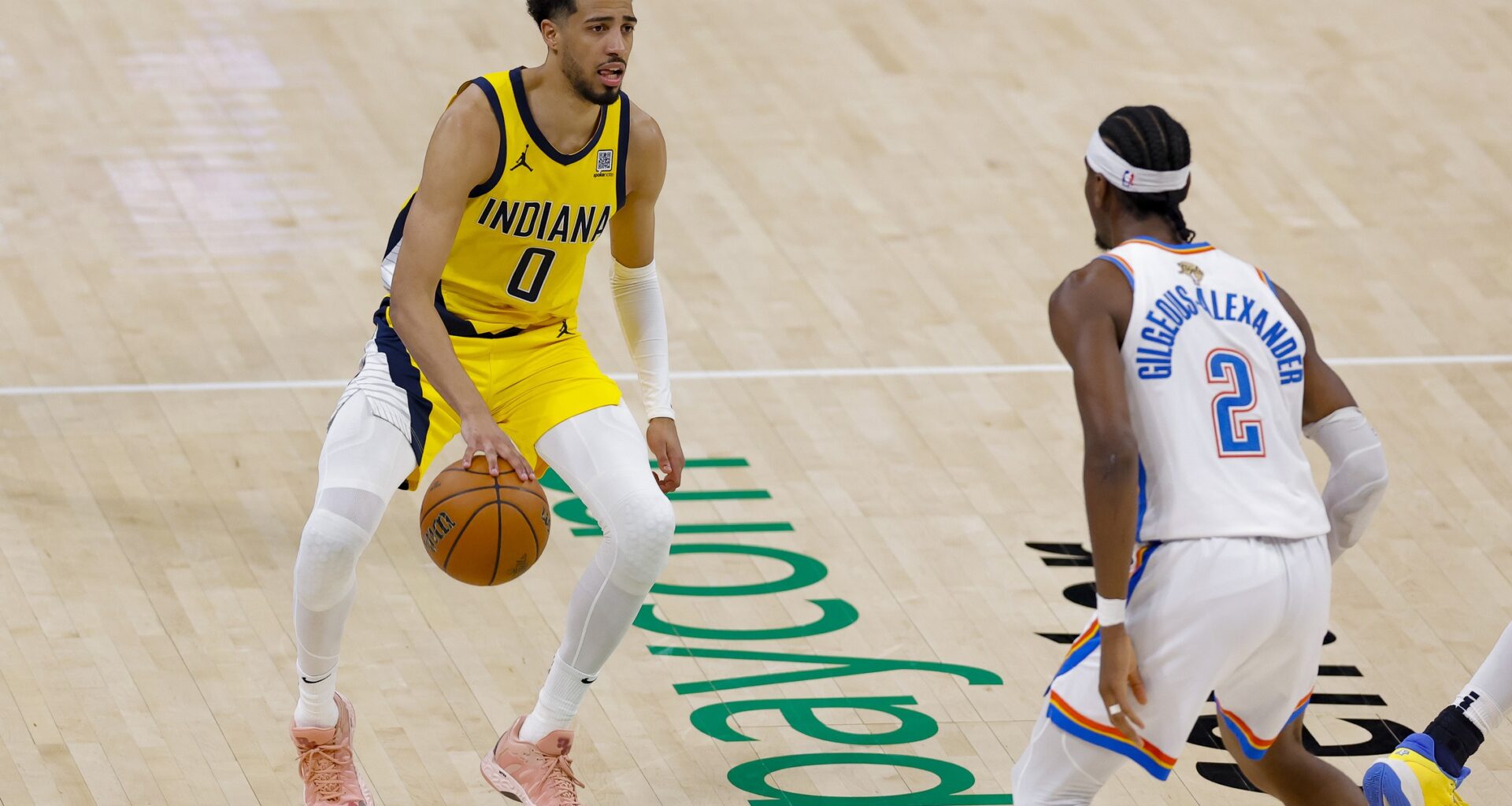 Indiana Pacers guard Tyrese Haliburton (0) brings the ball up court against Oklahoma City Thunder guard Shai Gilgeous-Alexander (2) during the third quarter in game five of the 2025 NBA Finals at Paycom Center.