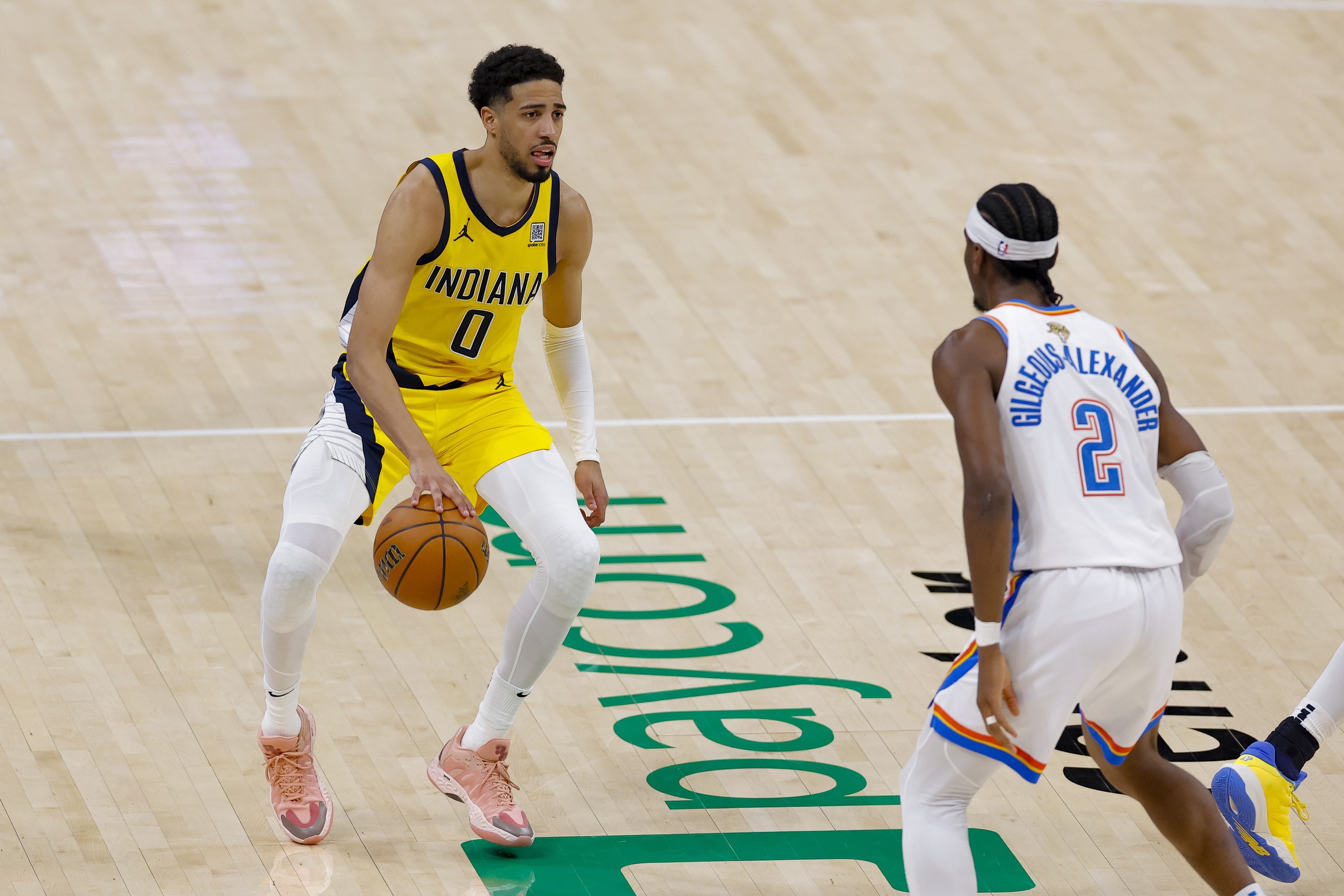 Indiana Pacers guard Tyrese Haliburton (0) brings the ball up court against Oklahoma City Thunder guard Shai Gilgeous-Alexander (2) during the third quarter in game five of the 2025 NBA Finals at Paycom Center.
