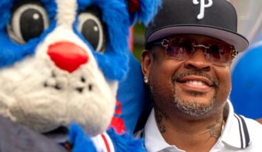 Allen Iverson poses with 76ers mascot Franklin the Dog.