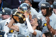 Indiana Pacers guard Tyrese Haliburton holds up the trophy after the Pacers won Game 6 of...