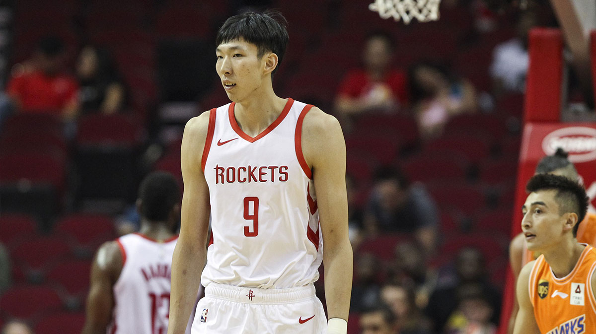 Houston Rockets forward Zhou Qi (9) reacts after a play during the first quarter against the Shanghai Sharks at Toyota Center.