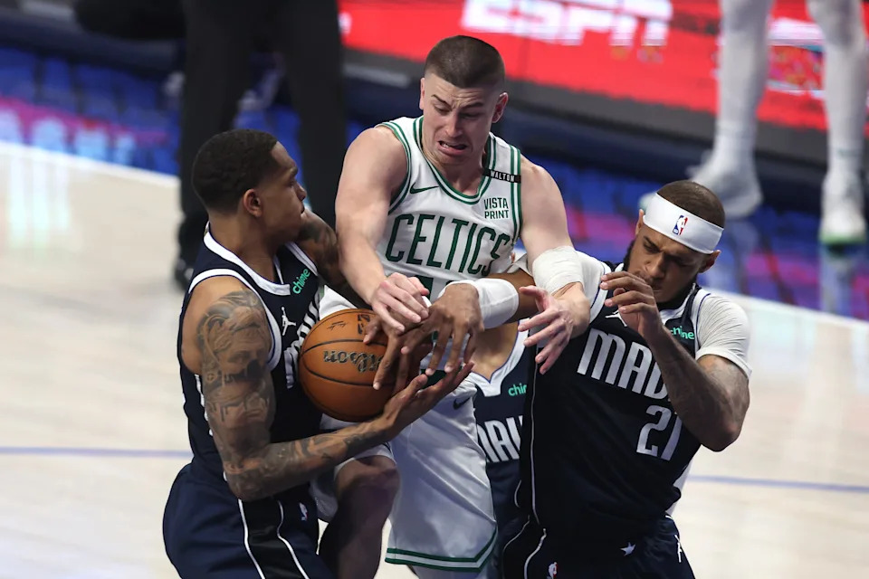 DALLAS, TEXAS - JUNE 12: Payton Pritchard #11 of the Boston Celtics battle for a loose ball against P.J. Washington #25 and Daniel Gafford #21 of the Dallas Mavericks in the second quarter in Game Three of the 2024 NBA Finals at American Airlines Center on June 12, 2024 in Dallas, Texas. NOTE TO USER: User expressly acknowledges and agrees that, by downloading and or using this photograph, User is consenting to the terms and conditions of the Getty Images License Agreement. (Photo by Tim Heitman/Getty Images)