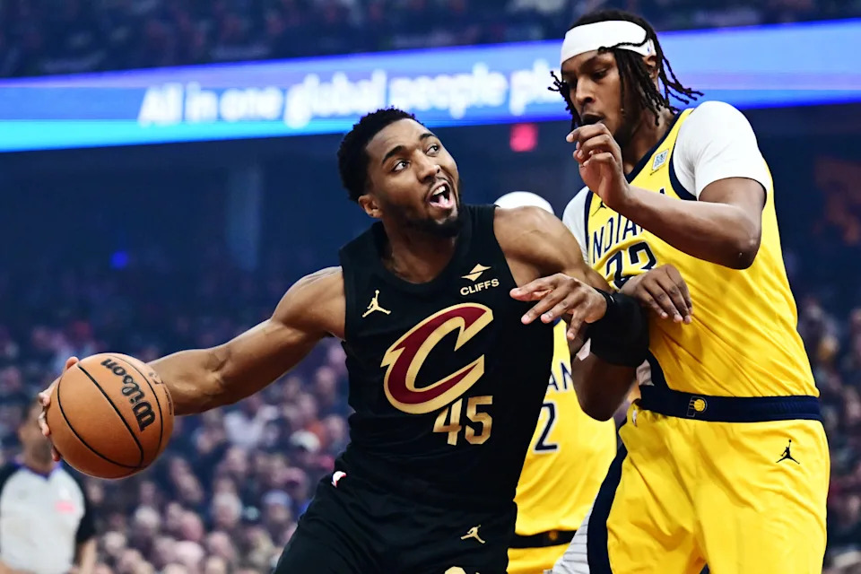 Cleveland Cavaliers guard Donovan Mitchell (45) drives to the basket against Indiana Pacers center Myles Turner (33) during Game 5 of a second-round playoff series May 13, 2025, in Cleveland, Ohio.