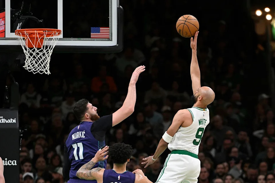 Apr 11, 2025; Boston, Massachusetts, USA; Boston Celtics guard Derrick White (9) shoots over Charlotte Hornets center Jusuf Nurkic (11) during the second half at TD Garden. Mandatory Credit: Eric Canha-Imagn Images