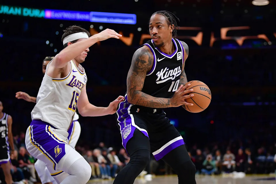 Dec 28, 2024; Los Angeles, California, USA; Sacramento Kings forward DeMar DeRozan (10) moves the ball against Los Angeles Lakers guard Austin Reaves (15) during the first half at Crypto.com Arena. © Gary A&period; Vasquez-Imagn Images