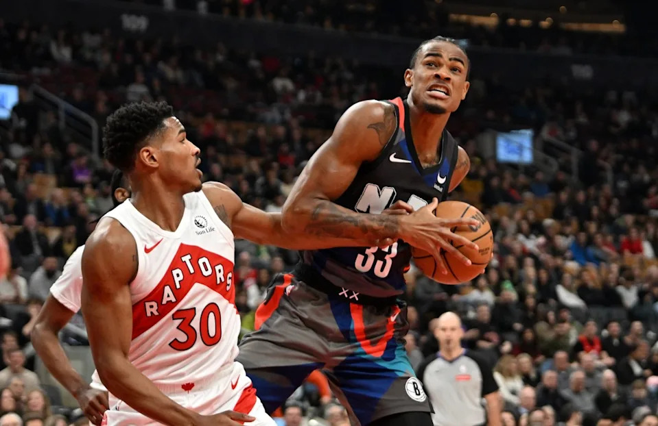 Brooklyn Nets center Nic Claxton takes a rebound away from Toronto Raptors guard Ochai Agbaji during their game at Scotiabank Arena on March 25, 2024.Dan Hamilton-Imagn Images