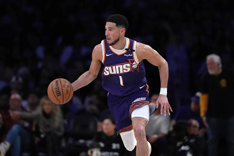 Phoenix Suns guard Devin Booker (1) dribbles the ball against the Los Angeles Lakers in the second half at Crypto.com Arena.Mandatory Credit&colon; Kirby Lee-Imagn Images