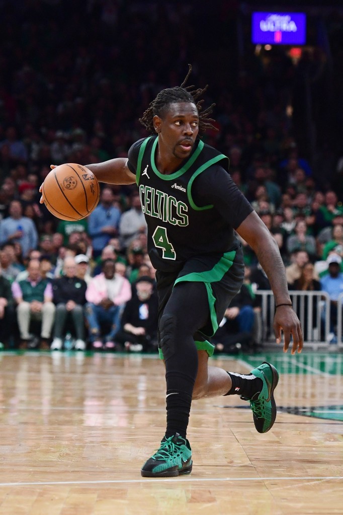 Jrue Holiday #4 of the Boston Celtics dribbling the ball.