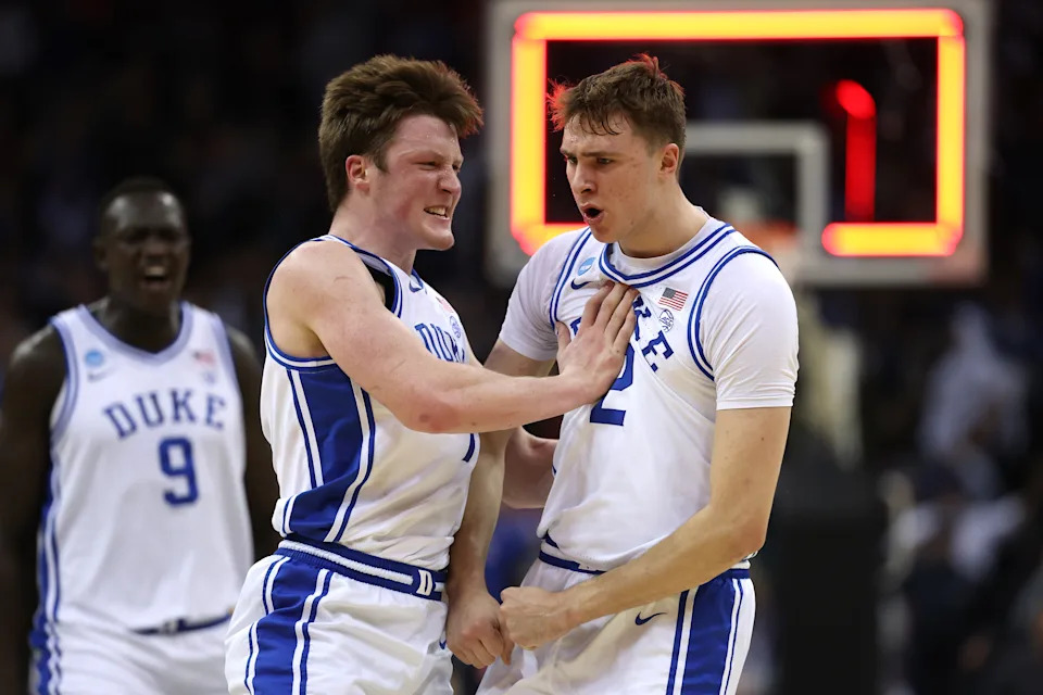 NEWARK, NEW JERSEY - MARCH 27: Cooper Flagg #2 and Kon Knueppel #7 of the Duke Blue Devils react after Flagg scored a three point basket to end the first half against the Arizona Wildcats in the East Regional Sweet Sixteen round of the NCAA Men's Basketball Tournament at Prudential Center on March 27, 2025 in Newark, New Jersey. (Photo by Patrick Smith/Getty Images)