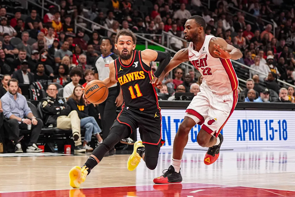 Atlanta Hawks guard Trae Young (11) and Miami Heat forward Andrew Wiggins (22).Dale Zanine-Imagn Images
