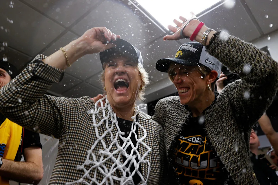 SEATTLE, WASHINGTON - MARCH 26: Head coach Lisa Bluder associate head coach Jan Jensen of the Iowa Hawkeyes celebrate after defeating the Louisville Cardinals 97-83 in the Elite Eight round of the NCAA Women's Basketball Tournament at Climate Pledge Arena on March 26, 2023 in Seattle, Washington. (Photo by Steph Chambers/Getty Images)