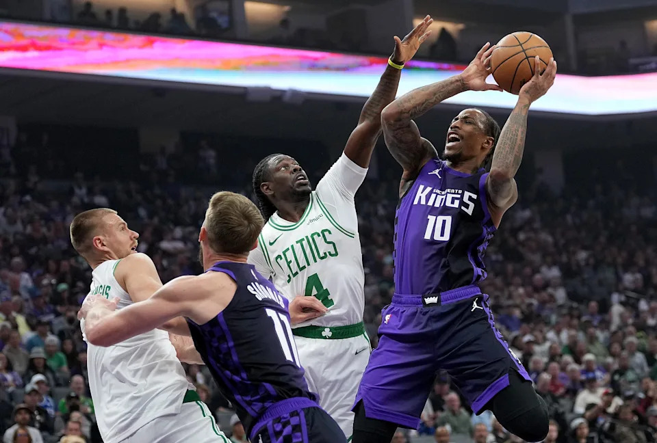 SACRAMENTO, CALIFORNIA - MARCH 24: DeMar DeRozan #10 of the Sacramento Kings goes up looking to shoot over Jrue Holiday #4 of the Boston Celtics during the first half at Golden 1 Center on March 24, 2025 in Sacramento, California. NOTE TO USER: User expressly acknowledges and agrees that, by downloading and or using this photograph, User is consenting to the terms and conditions of the Getty Images License Agreement. (Photo by Thearon W. Henderson/Getty Images)