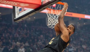 Cleveland Cavaliers' Evan Mobley (4) dunks against the New York Knicks during the first half of an NBA basketball game in Cleveland, Friday, Feb. 21, 2025.