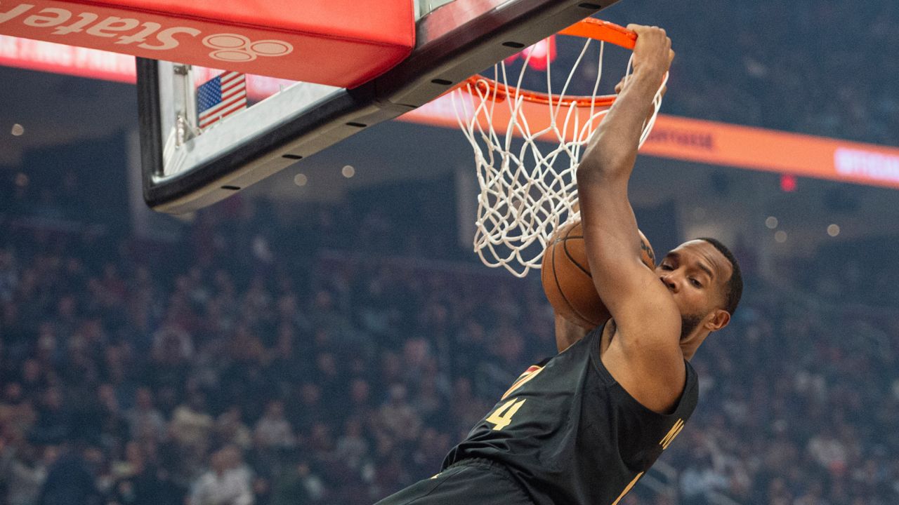 Cleveland Cavaliers' Evan Mobley (4) dunks against the New York Knicks during the first half of an NBA basketball game in Cleveland, Friday, Feb. 21, 2025.