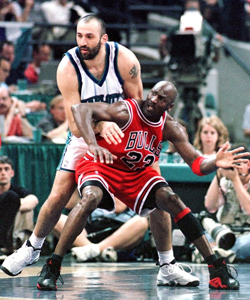 Michael Jordan of the Chicago Bulls defending Vlade Divac of the Charlotte Hornets.