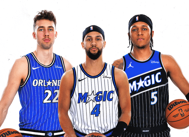 From left to right, Magic teammates Franz Wagner, Jalen Suggs and Paolo Banchero show off Orlando's three new uniforms. (Courtesy of Magic)