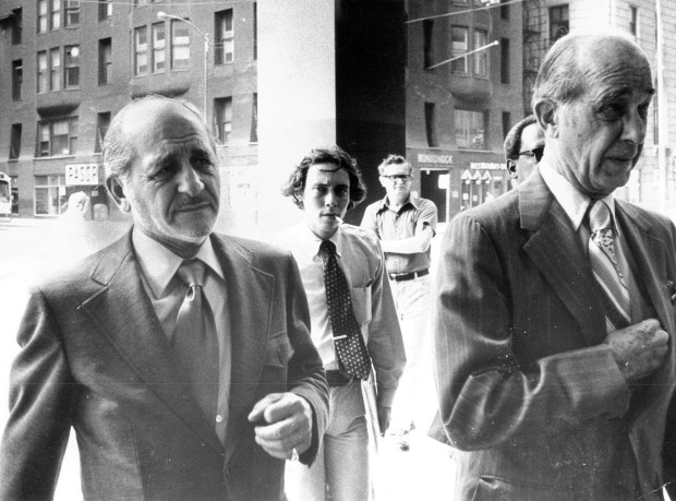 Sam Giancana, left, with his attorney George Callaghan, enter the Dirksen Building where Giancana was to appear before a federal grand jury on July 23, 1974. (James O'Leary/Chicago Tribune) 