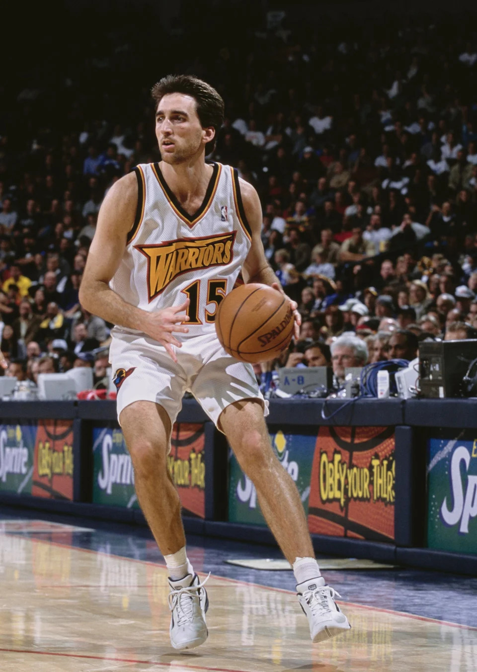 Vinny Del Negro #15, Point Guard for the Golden State Warriors dribbles the basketball down court during the NBA Pacific Division basketball game against the Toronto Raptors on 8th December 2000 at The Arena in Oakland, Oakland, California, United States. The Toronto Raptors won the game 108 - 92. (Photo by Jed Jacobsohn/Getty Images)