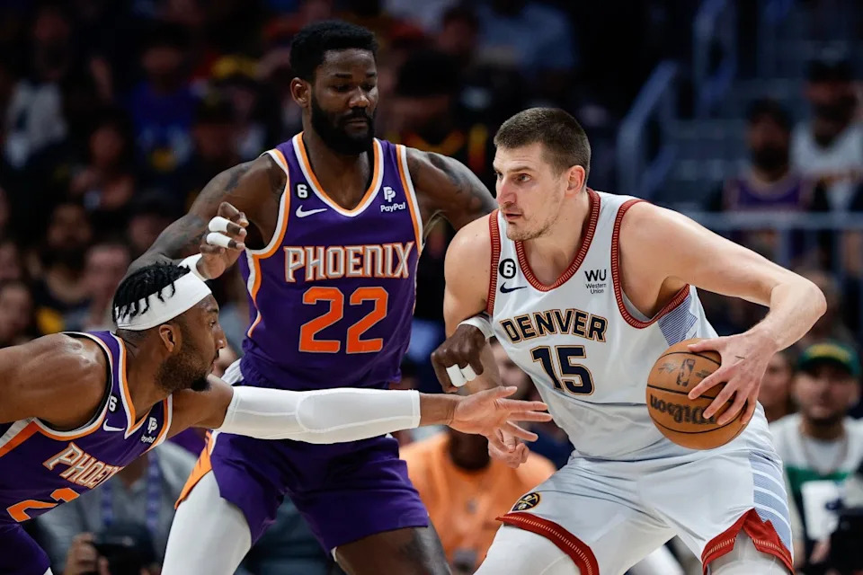 Former Phoenix Suns center DeAndre Ayton (22) guards Denver Nuggets center Nikola Jokic (15).Isaiah J&period; Downing-USA TODAY Sports