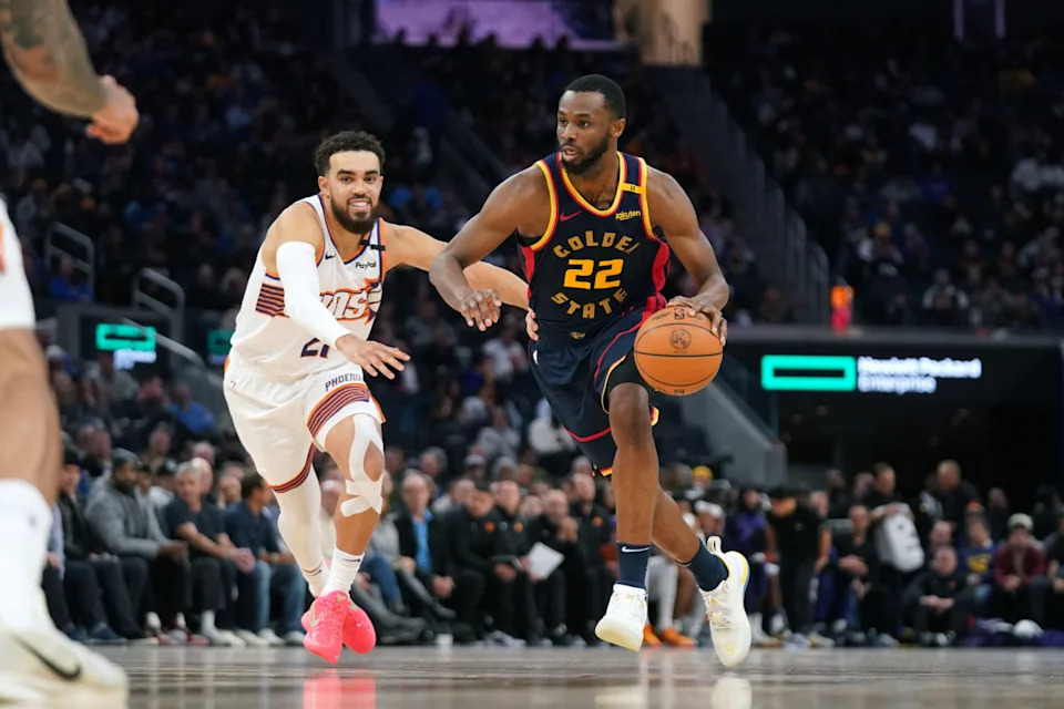 Jan 31, 2025; San Francisco, California, USA; Golden State Warriors forward Andrew Wiggins (22) dribbles past Phoenix Suns guard Tyus Jones (21) in the fourth quarter at the Chase Center.© Cary Edmondson-Imagn Images