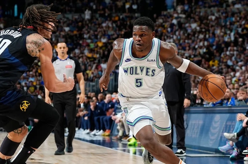 Minnesota Timberwolves guard Anthony Edwards, right, drives past Denver Nuggets forward Aaron Gordon in the second half of Game 7 of an NBA second-round playoff series, Sunday, May 19, 2024, in Denver. | David Zalubowski