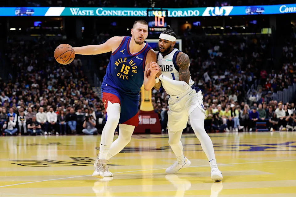 Nov 22, 2024; Denver, Colorado, USA; Denver Nuggets center Nikola Jokic (15) controls the ball under pressure from Dallas Mavericks guard Jaden Hardy (1) in the first quarter at Ball Arena. © Isaiah J&period; Downing-Imagn Images