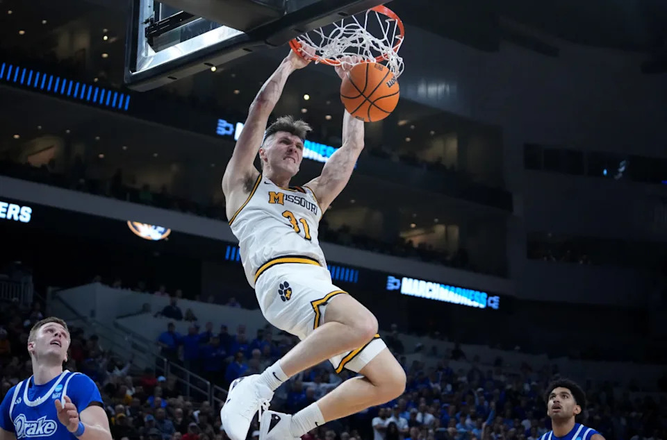Missouri Tigers guard Caleb Grill (31) dunks in the second half of a first round men's NCAA Tournament game.Kirby Lee-Imagn Images