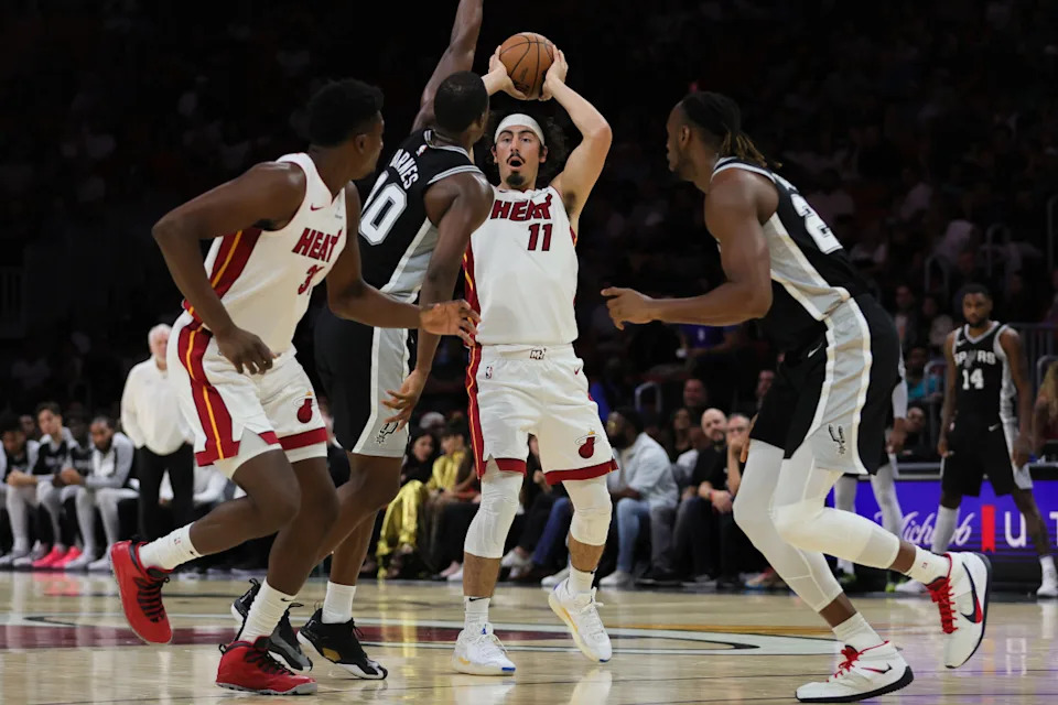 Oct 15, 2024; Miami, Florida, USA; Miami Heat guard Jaime Jaquez Jr. (11) protects the basketball against San Antonio Spurs forward Harrison Barnes (40) during the third quarter at Kaseya Center.© Sam Navarro-Imagn Images