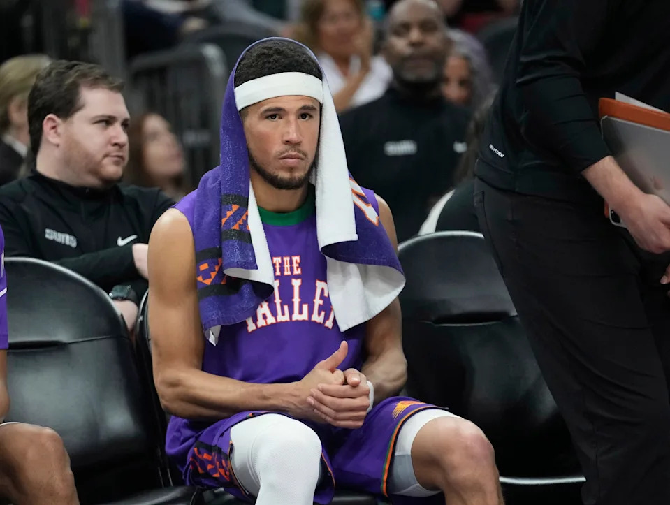 Phoenix Suns guard Devin Booker watches from the bench during the fourth quarter against the Houston Rockets at PHX Arena in Phoenix on March 30, 2025.