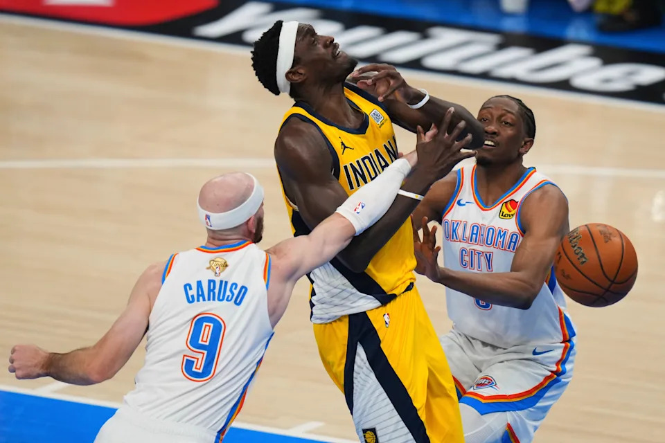 Oklahoma City Thunder guard Alex Caruso (9) fouls Indiana Pacers forward Pascal Siakam (43) during the first half of Game 1 of the NBA Finals basketball series Thursday, June 5, 2025, in Oklahoma City. (AP Photo/Nate Billings)