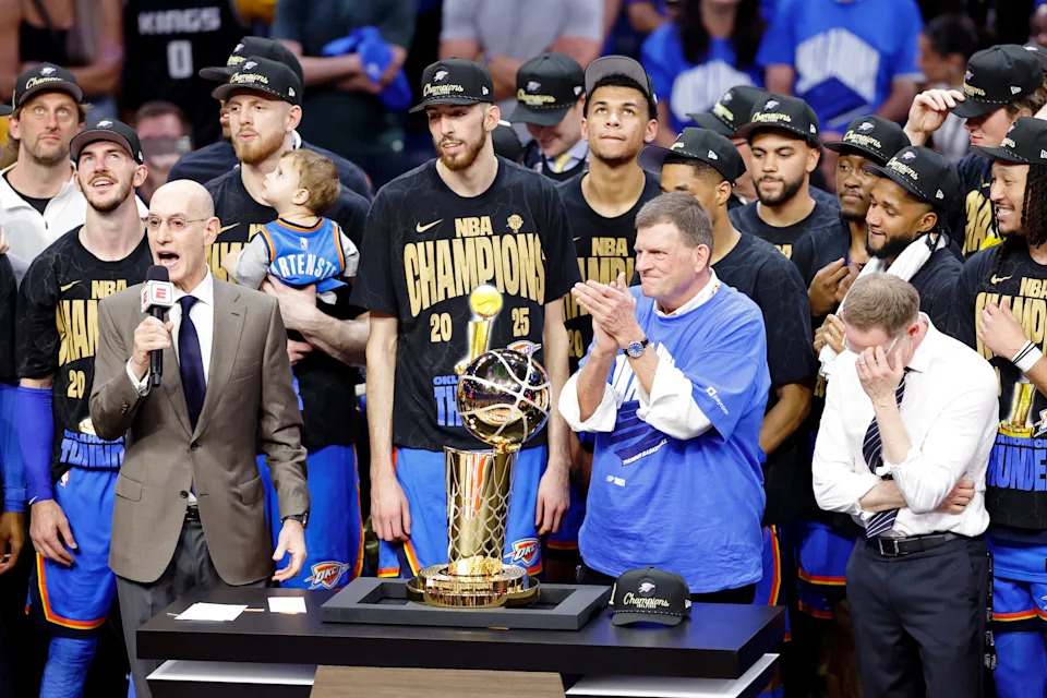 Jun 22, 2025; Oklahoma City, Oklahoma, USA; NBA commissioner Adam Silver presents Oklahoma City Thunder owner Clay Bennett the trophy after winning game seven of the 2025 NBA Finals against the Indiana Pacers at Paycom Center. Mandatory Credit: Alonzo Adams-Imagn Images