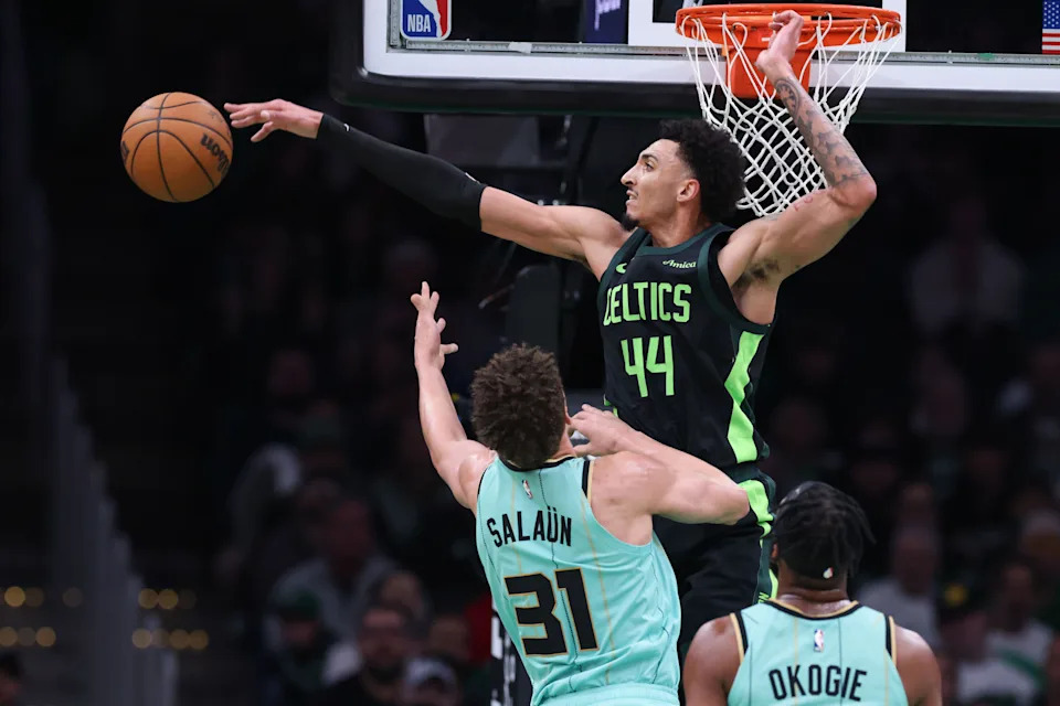 Apr 13, 2025; Boston, Massachusetts, USA; Boston Celtics forward Miles Norris (44) blocks Charlotte Hornets forward Tidjane Salaun (31) during the first half at TD Garden. Mandatory Credit: Paul Rutherford-Imagn Images