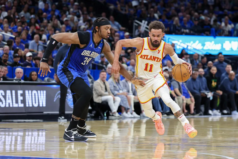 Atlanta Hawks guard Trae Young is guarded by Orlando Magic center Wendell Carter Jr.Nathan Ray Seebeck-Imagn Images