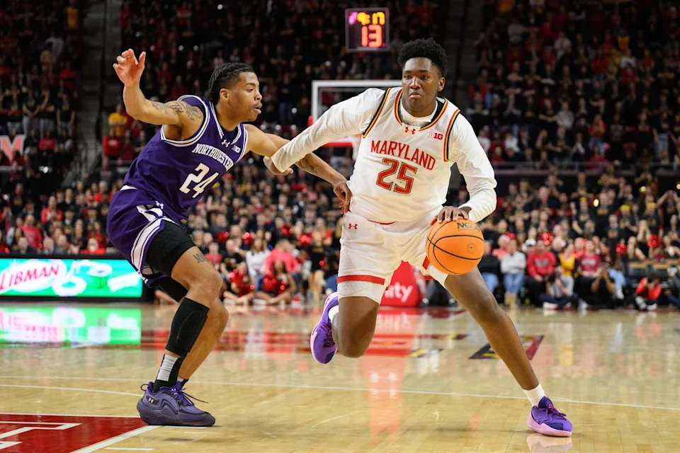 Mar 8, 2025; College Park, Maryland, USA; Maryland Terrapins center Derik Queen (25) handles the ball against Northwestern Wildcats guard K.J. Windham (24) during the second half at Xfinity Center. Mandatory Credit: Reggie Hildred-Imagn Images