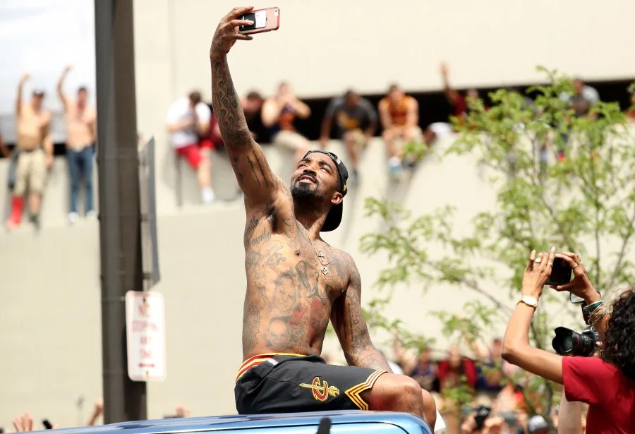 J.R. Smith #5 of the Cleveland Cavaliers takes a photo as the crowd cheers during the Cleveland Cavaliers 2016 NBA Championship victory parade and rally on June 22, 2016 in Cleveland, Ohio. (Photo by Mike Lawrie/Getty Images)