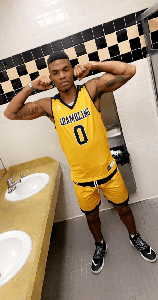 Basketball player in Grambling State jersey flexing biceps.