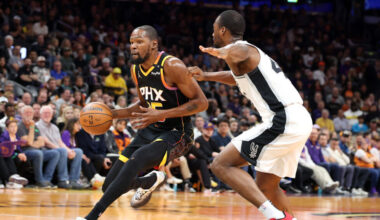 Kevin Durant #35 of the Phoenix Suns drives to the basket against Harrison Barnes #40 of the San An...