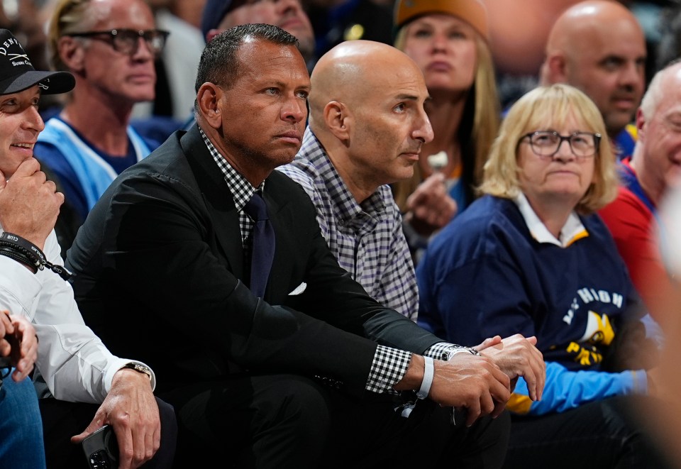 Alex Rodriguez and Marc Lore, minority owners of the Minnesota Timberwolves, seated at a basketball game.