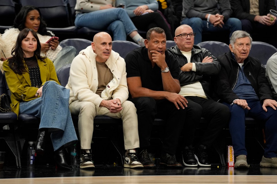 Minnesota Timberwolves minority owners Marc Lore and Alex Rodriguez at a basketball game.