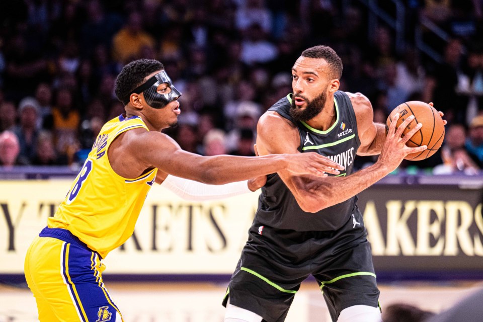 Rudy Gobert of the Minnesota Timberwolves guarded by Rui Hachimura of the Los Angeles Lakers during an NBA Playoffs game.