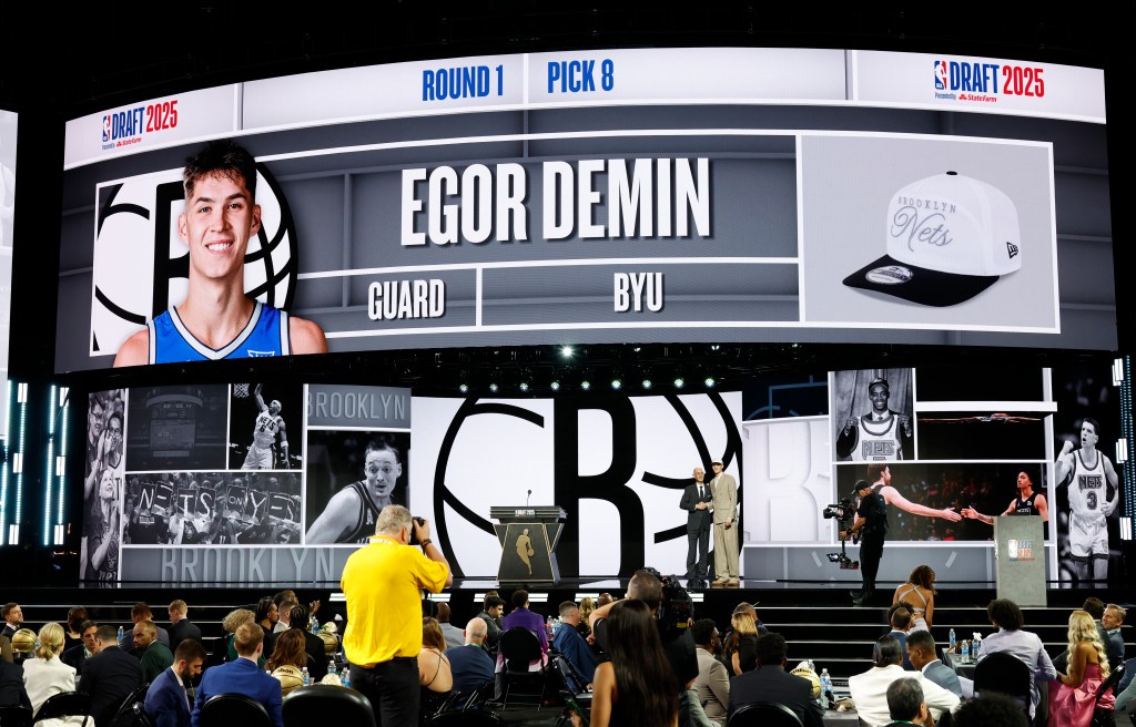 NBA Commissioner Adam Silver shakes hands with the Number #8 pick of the Brooklyn Nets Egor Demin during the NBA Draft