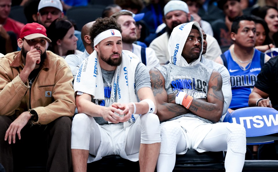 Kyrie Irving and Klay Thompson sitting on the bench.