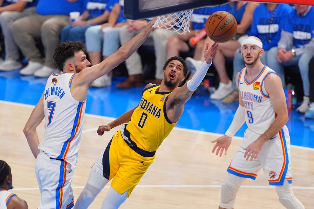 Tyrese Haliburton of the Indiana Pacers shoots the basketball while Chet Holmgren of the Oklahoma City Thunder defends.