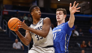 Thomas Sorber #35 of the Georgetown Hoyas attempts a pass past Ryan Kalkbrenner #11 of the Creighto...