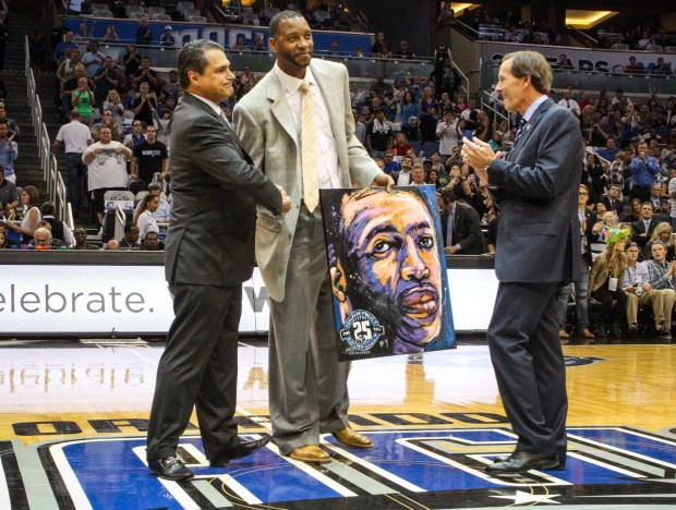 2013: Former Orlando Magic star Tracy McGrady shakes hands with...