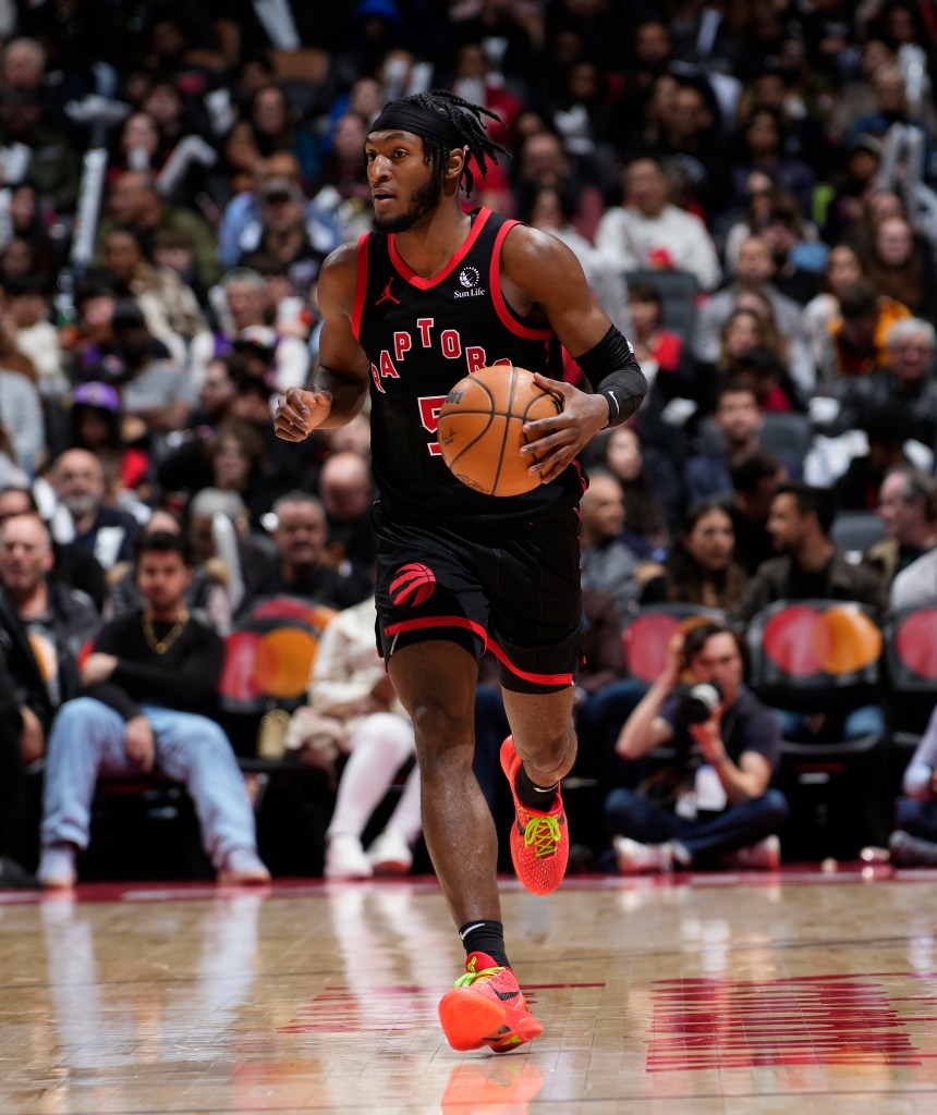Immanuel Quickley #5 of the Toronto Raptors dribbling the ball.