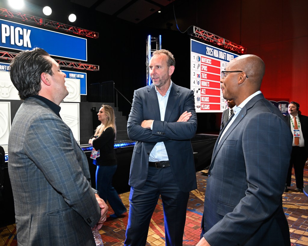 Three men in suits at the 2025 NBA Draft Lottery.